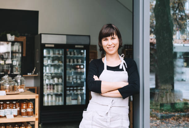 portrait of owner of sustainable small local business. shopkeeper of zero waste shop standing on interior background of shop. - small business built structure retail imagens e fotografias de stock