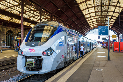 Strasbourg, France - September 16, 2019: A Regiolis TER regional train from french company SNCF is stationing at the platform in the SNCF train station waiting for passengers to get on.