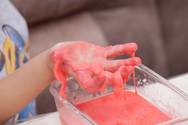 istock Closeup of kids hand holding substance, cornstarch and water mixture, doing a science experiment 1190363590