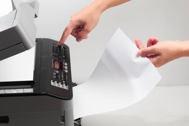 istock Hand press button on panel of printer. printer scanner laser office copy machine supplies start concept 1190363656