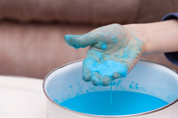 istock Closeup of kids hand holding substance, cornstarch and water mixture, doing a science experiment 1190363663