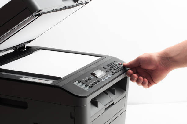 istock Hand press button on panel of printer. printer scanner laser office copy machine supplies start concept 1190363681