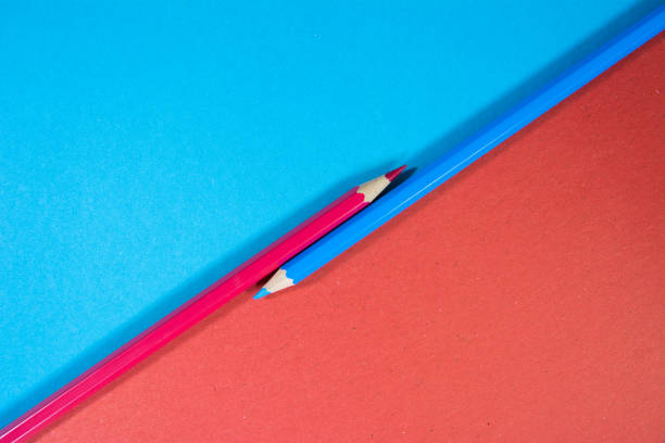 istock Blue and Red color pencils on blue and red color background 1190365539