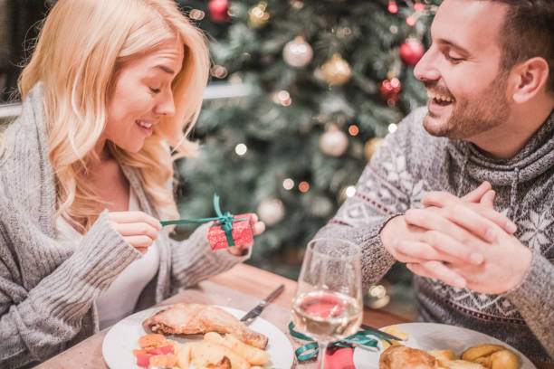 istock A handsome young couple having a candlelit dinner on Christmas eve. 1190365702