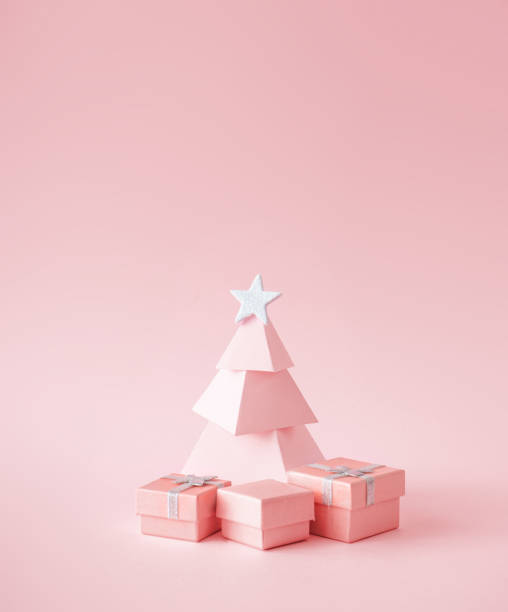 istock Christmas composition. Pink Christmas tree, with presents on pink background. 1190366845