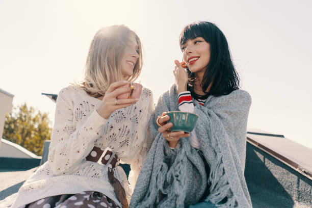 istock Two attractive girls enjoy a tea party 1190366879