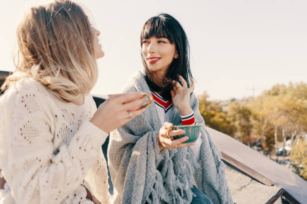 istock Two attractive girls enjoy a tea party 1190366887