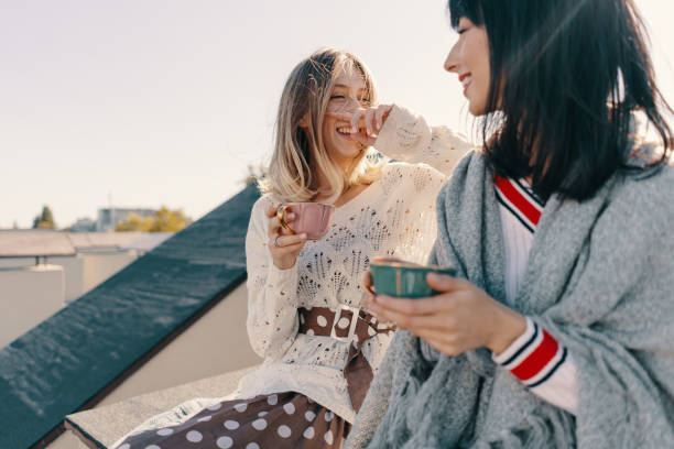 istock Two attractive girls enjoy a tea party 1190366893