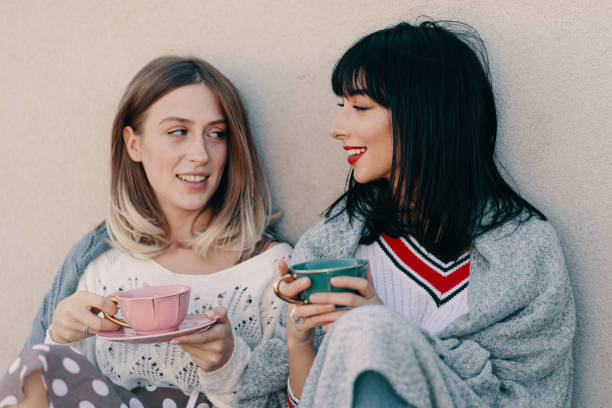istock Two attractive girls enjoy a tea party 1190366896