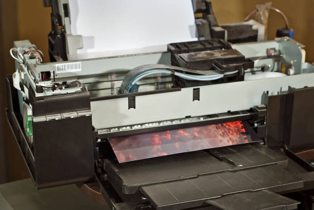 old broken printer in workshop. the concept of cleaning and calibrating printers. sunset and red sky with clouds in the photo. picturesque nature photo printed on printing equipment. - photobusiness imagens e fotografias de stock