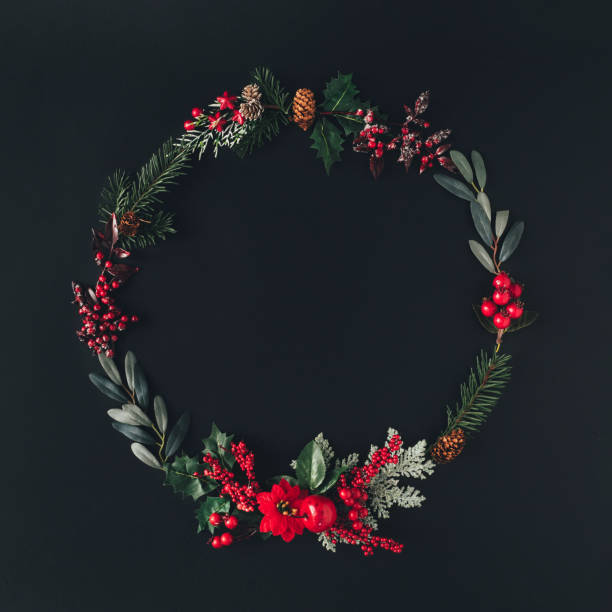 istock Christmas round frame made of natural winter things on dark blackboard. 1190367412