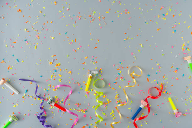 istock Creative composition made with colorful party streamers and confetti on pastel grey background. 1190367437