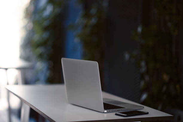 istock Modern working area, white table with laptop, smartphone on it. 1190368205