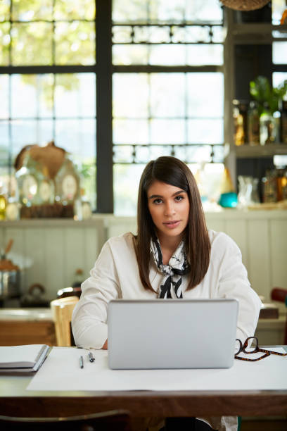 istock Businesswoman using laptop in cafe. 1190368223