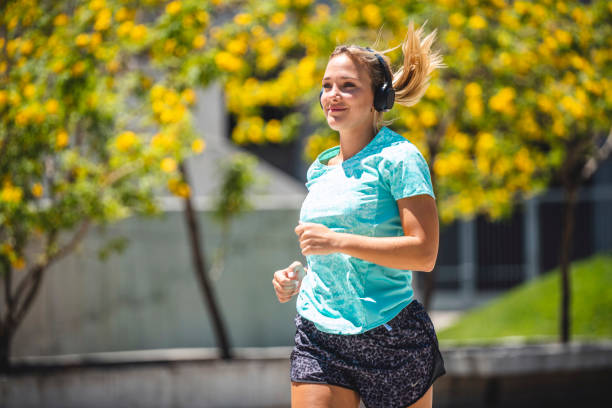 istock Smiling Female Runner Enjoying Morning Exercise in Park 1190368311