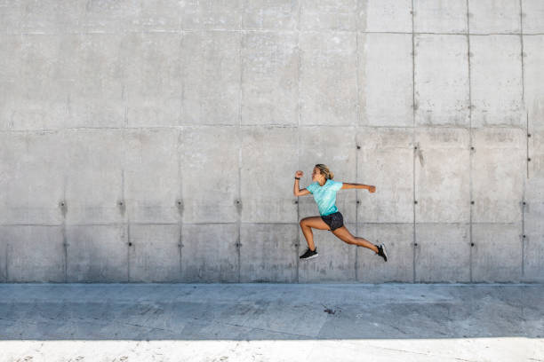 istock Female Runner at Full Stride with High Knee Action 1190368341