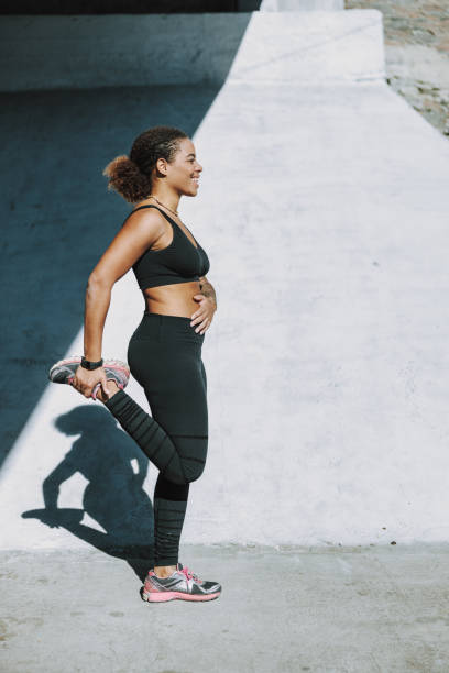 istock Cheerful Afro American lady doing exercise on the street 1190369572