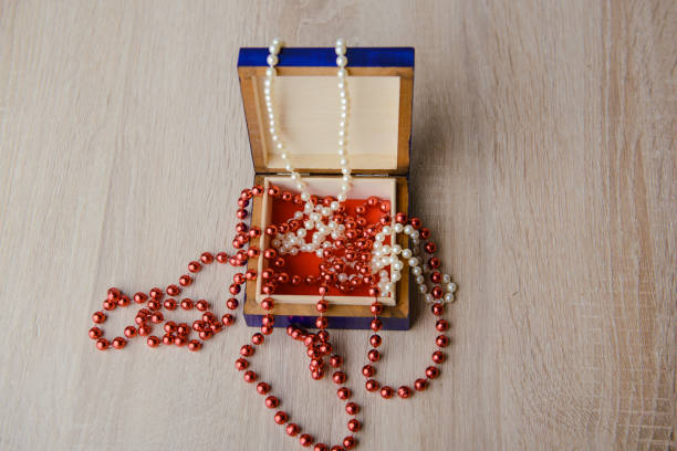 istock Gift box and red beads necklace on wooden background 1190369859