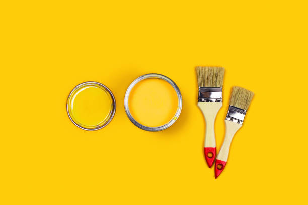 istock Colored background with paint jar and brushes. 1190370660