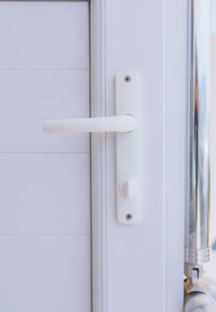 istock Plastic white vinyl door handle on the white vinyl door 1190371903