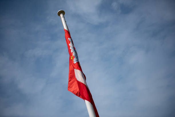 istock Polish national flags on a building in a slight breeze 1190371942