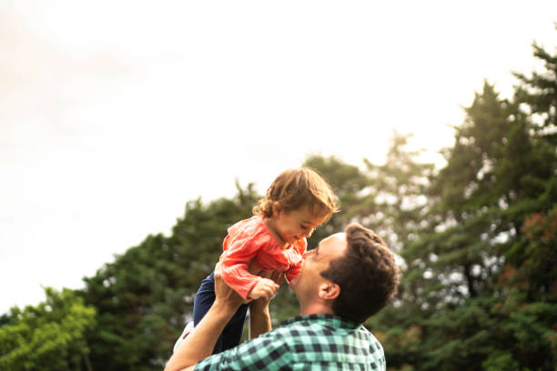 istock Happy father throws up child daughter and having fun at home 1190372003