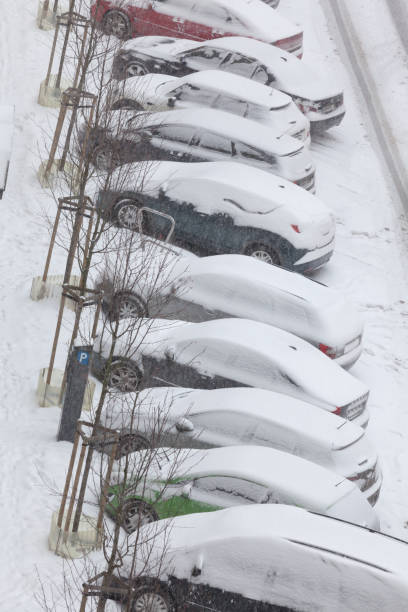 istock Parked cars covered in snow after blizzard top view 1190373381