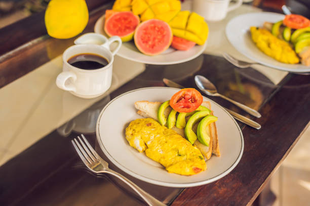 A delicious breakfast consisting of omelet, fruit and coffee.