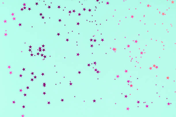 istock Purple stars glitter confetti on mint background. Festive backdrop. 1190376435