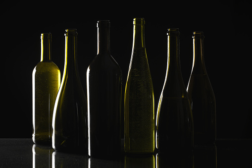 Different wine bottles on black background