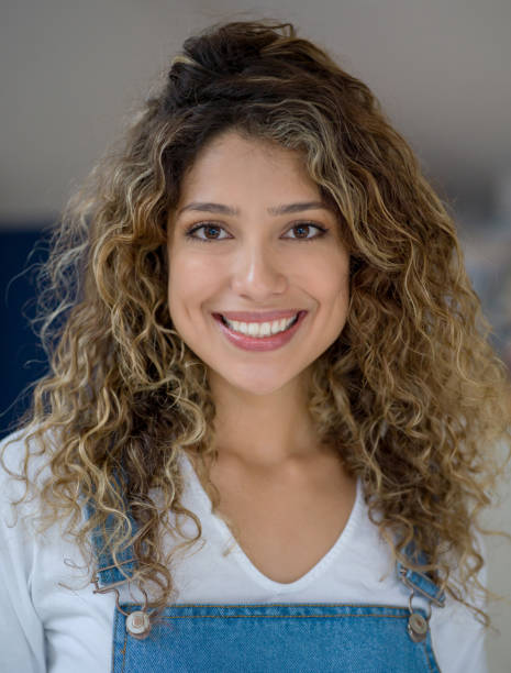 istock Beautiful young woman at home facing camera smiling - Front view 1190377045