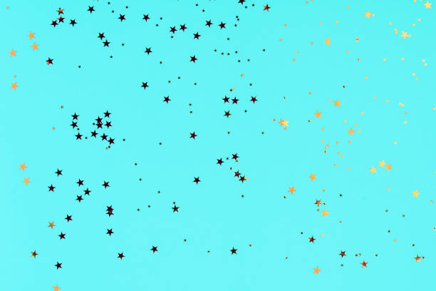 istock Golden stars glitter confetti on blue background. Festive backdrop. 1190378003