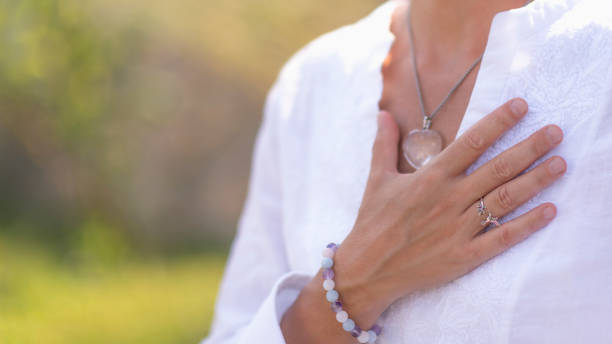 Gratefulness Meditation Hand Gesture Gratefulness – Woman expressing gratitude with hands. Close up image of female hands in prayer position outdoor. Self-care practice for wellbeing meditation hands stock pictures, royalty-free photos & images