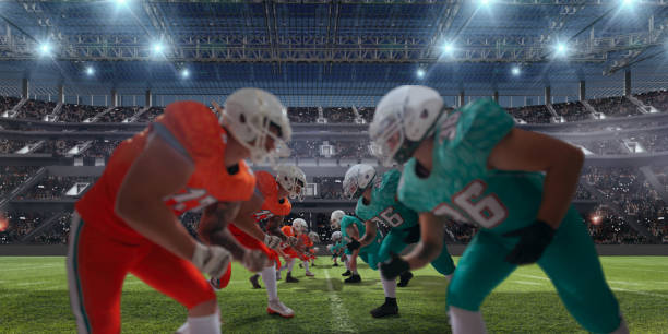 AMERICAN FOOTBALL. American football players in professional sport stadium. football field night american culture empty stock pictures, royalty-free photos & images