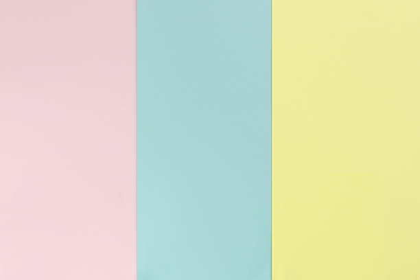 istock Yelllow pink blue color paper background. Geometric flat composition. Empty space on monochrome cardboard. 1190378727