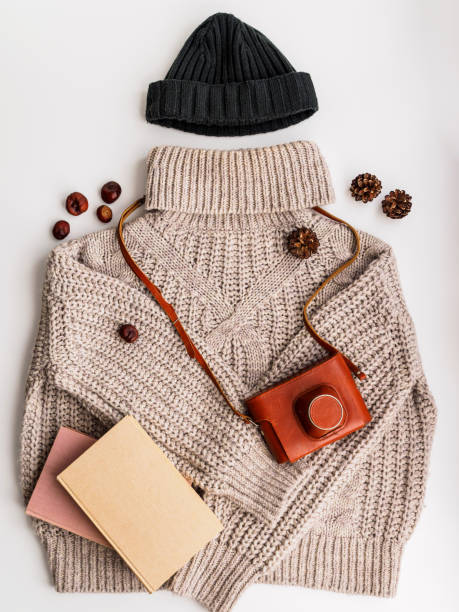 istock A warm wool sweater and an old camera in a leather case. Hat and books 1190378951
