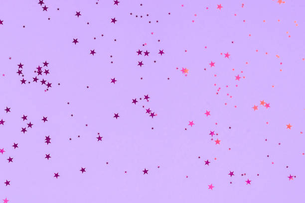istock Purple stars glitter confetti on mint background. Festive backdrop. 1190380347