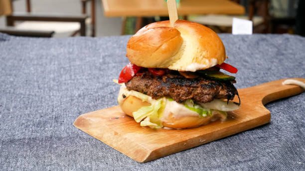istock Meaty hamburger in a restaurant 1190381023