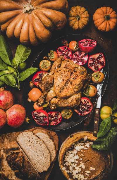 istock Thanksgiving table with roasted chicken and pumpkin pie, top view 1190381754