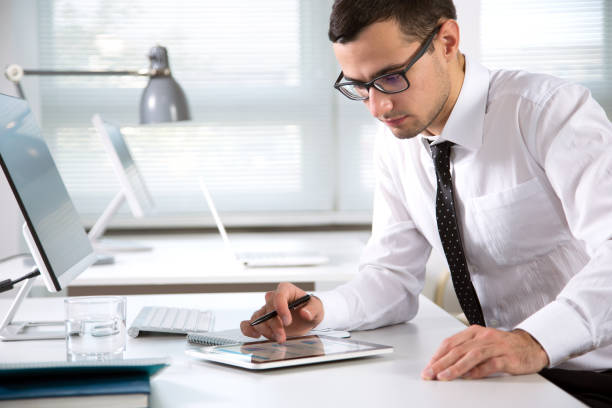 istock Young handsome businessman working in an office 1190382857