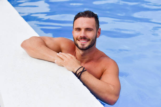 istock Young man in the pool enjoys and relaxes 1190384871