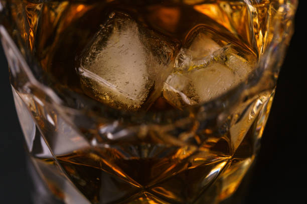 istock Glass of whiskey on dark table 1190390221