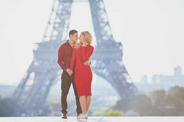 Romantic couple in love near the Eiffel tower Romantic couple in love near the Eiffel tower in Paris, France teenager couple child blond hair stock pictures, royalty-free photos & images