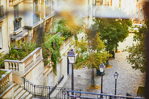 Beautiful street with stairs and lanterns on famous Montmartre hill in Paris, France, taken at early morning