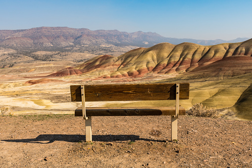 Detail of a bench facing the colorful landscape in Painted Hills Overlook, Oregon, USA.
