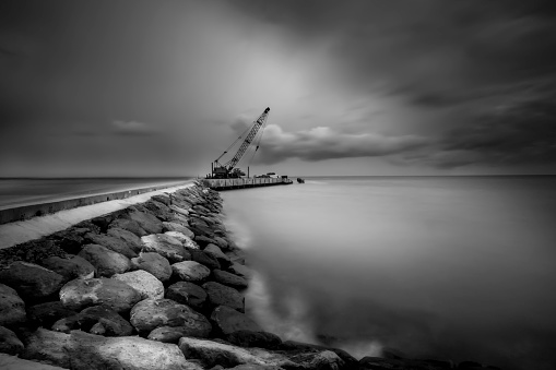 long exposure shot of a harbor/coastal scene with the crane as main subject