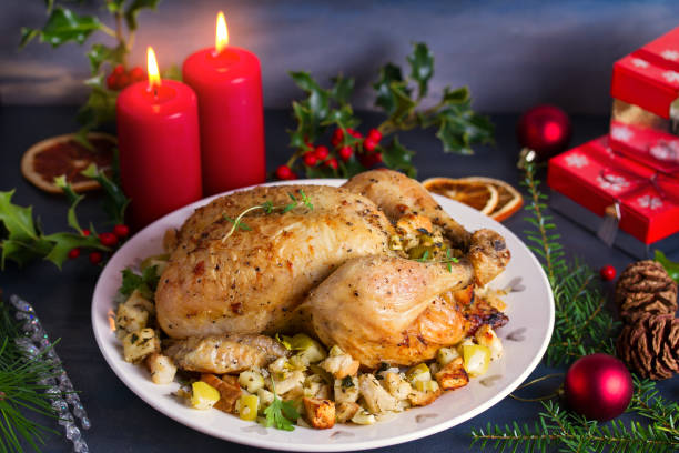 Roasted chicken with apple and bread stuffing. Christmas decorations. Dish for Christmas Eve. New Year food menu