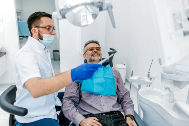 istock Dentist explaining tooth x-rays to a male patient 1190393475