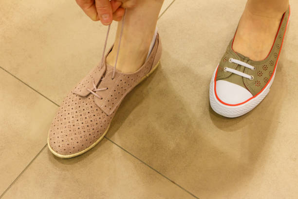 istock Unrecognizable woman trying on shoes 1190396042