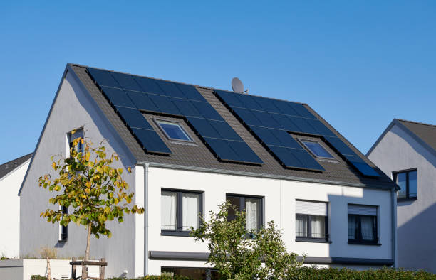 White twin house with solar panels on the roof Duesseldorf, Germany- October, 31, 2019: White semi-detached house with solar panels on the roof, new development area in the northeast of Duesseldorf. solar power station solar panel house solar energy stock pictures, royalty-free photos & images